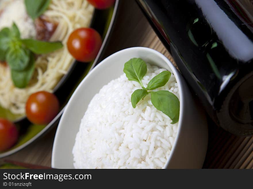 A bowl of perfectly cooked, plain Basmati rice, in an Asian style bowl, with a garnish of Thai Basil. A bowl of perfectly cooked, plain Basmati rice, in an Asian style bowl, with a garnish of Thai Basil