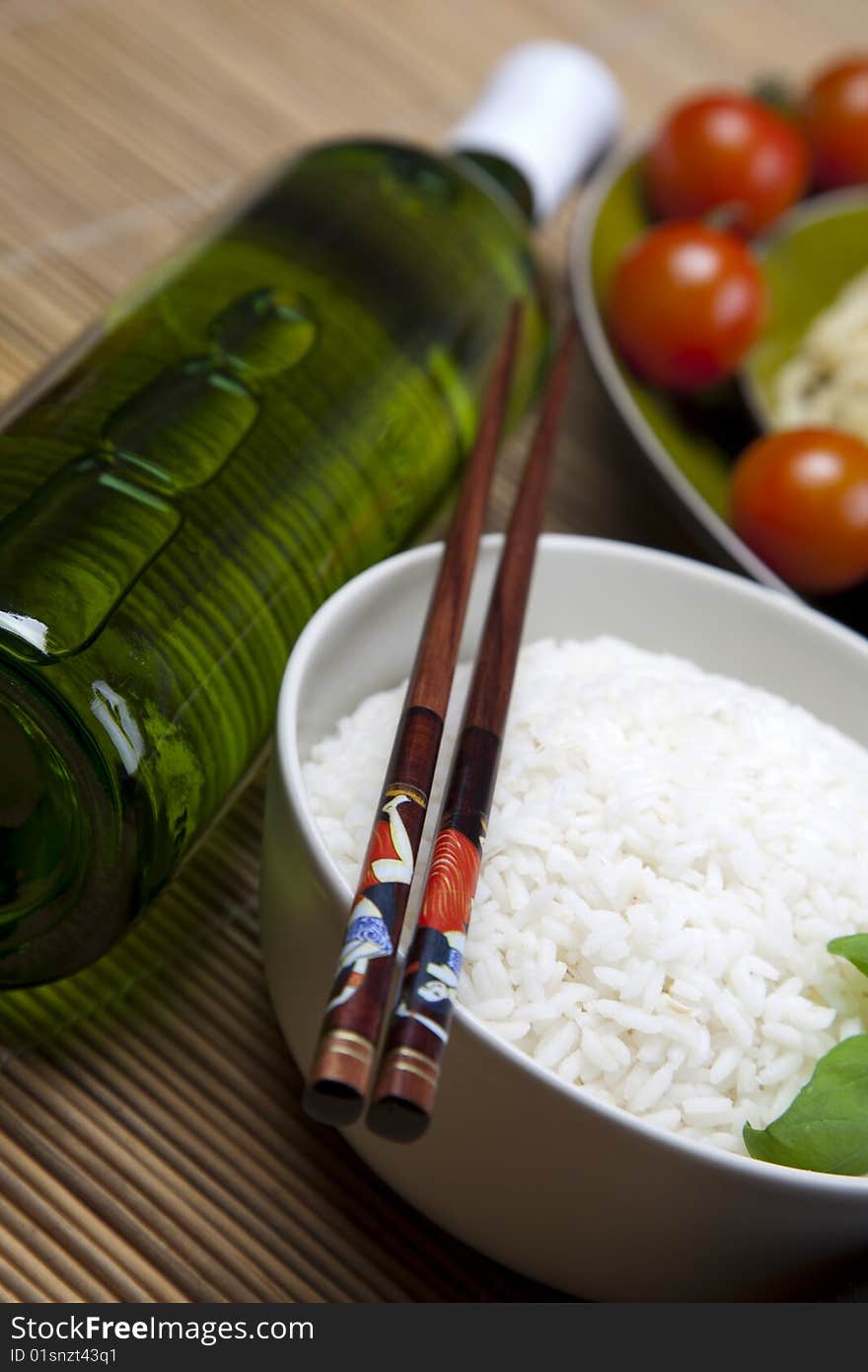 A bowl of perfectly cooked, plain Basmati rice, in an Asian style bowl, with a garnish of Thai Basil. A bowl of perfectly cooked, plain Basmati rice, in an Asian style bowl, with a garnish of Thai Basil