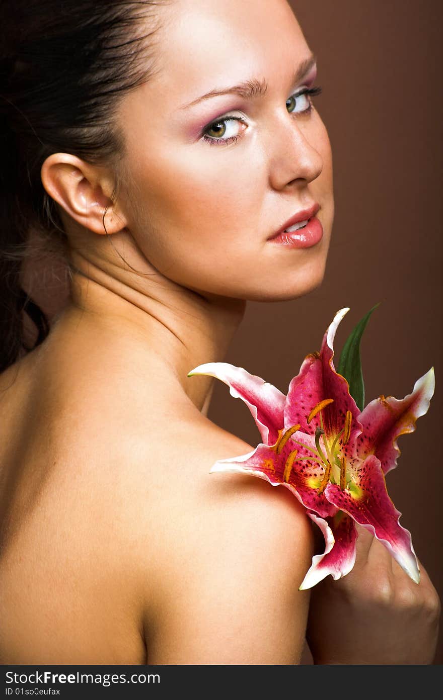 Beauty portrait of a young woman with a lily flower. Beauty portrait of a young woman with a lily flower