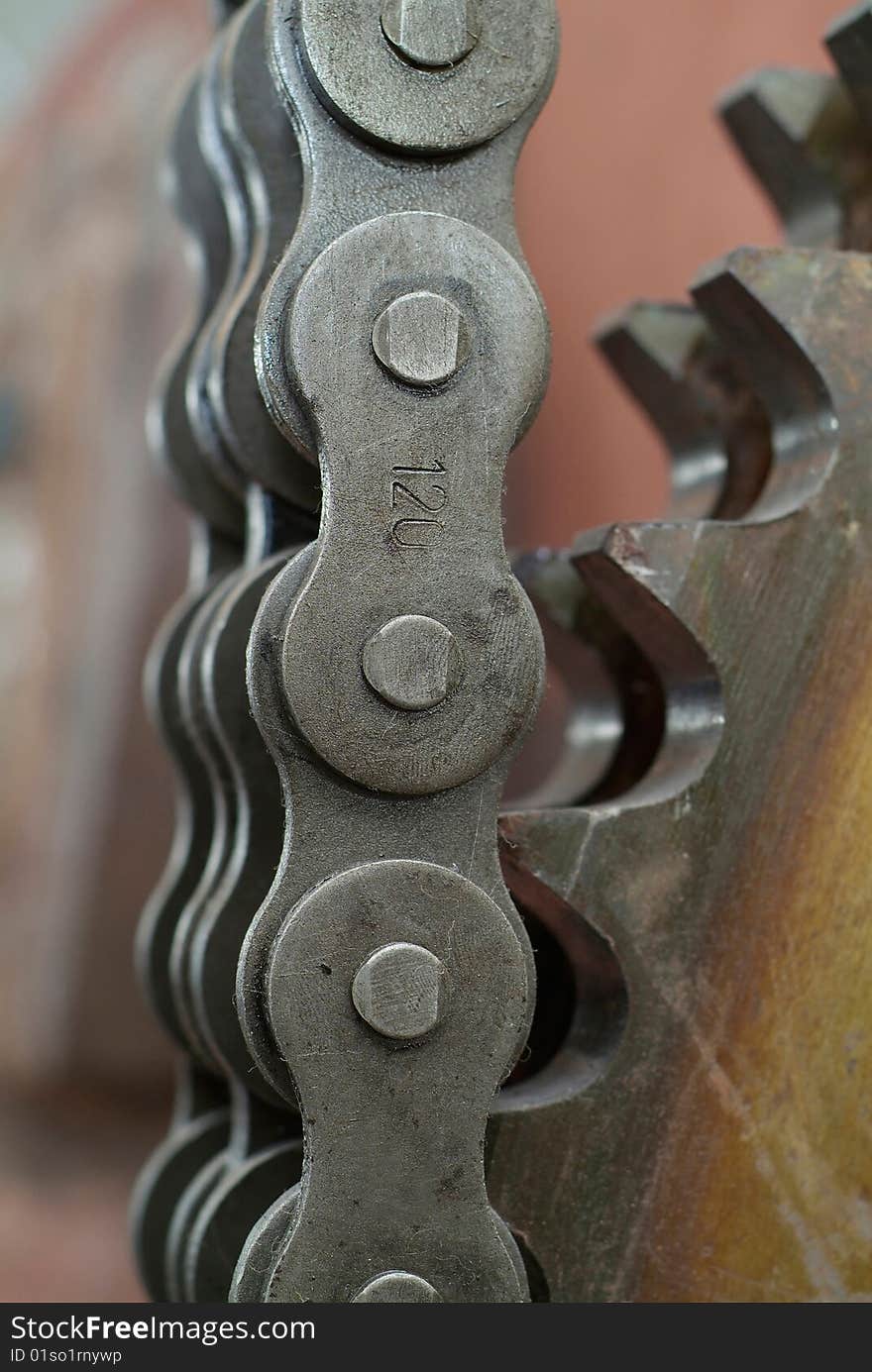 Close-up of heavy duty chain and cogwheel