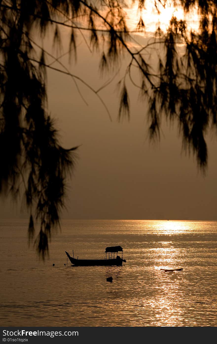 Yellow sunrise with a fishing boat and foliage. Yellow sunrise with a fishing boat and foliage