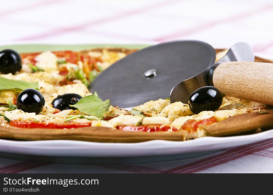 Baked pizza served on a green plate