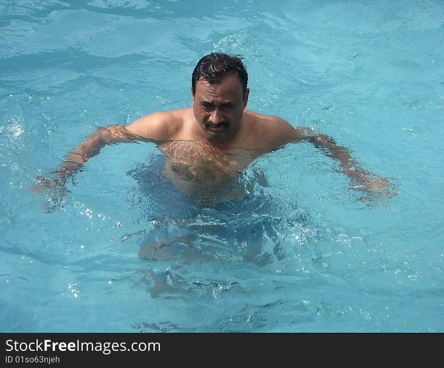 A person trying to swim by spreading the hands. A person trying to swim by spreading the hands.