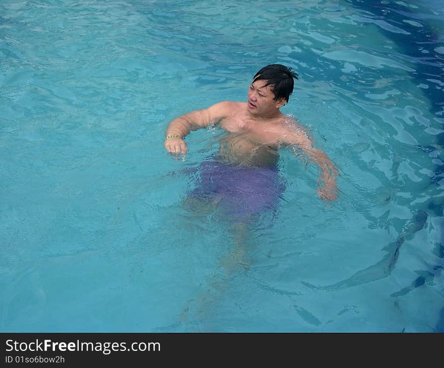 A young Tibetan floating happily in the pool. A young Tibetan floating happily in the pool.