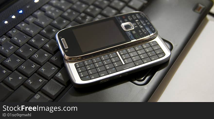 Modern Mobile Phone On A Laptop