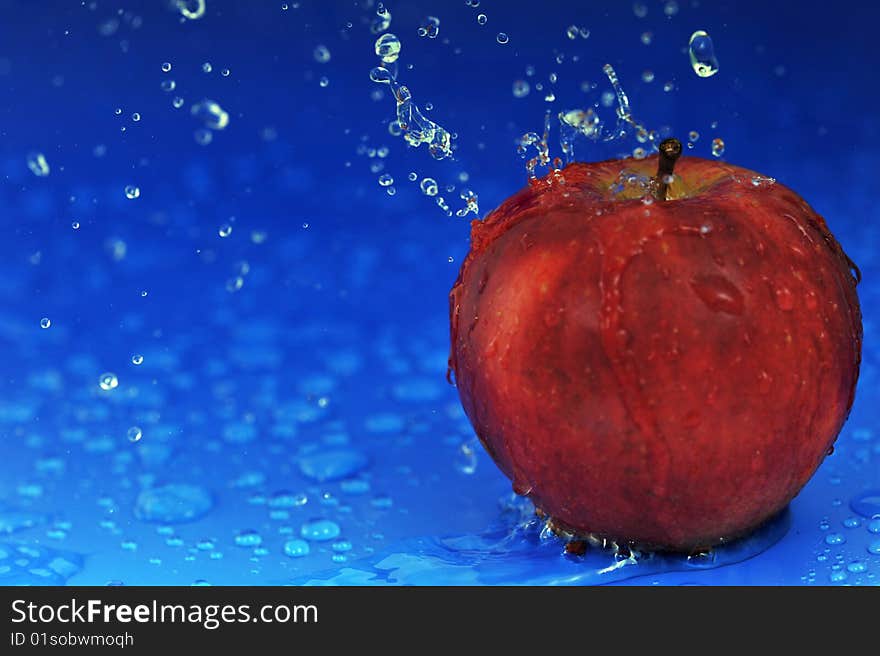 Red apple and water drops