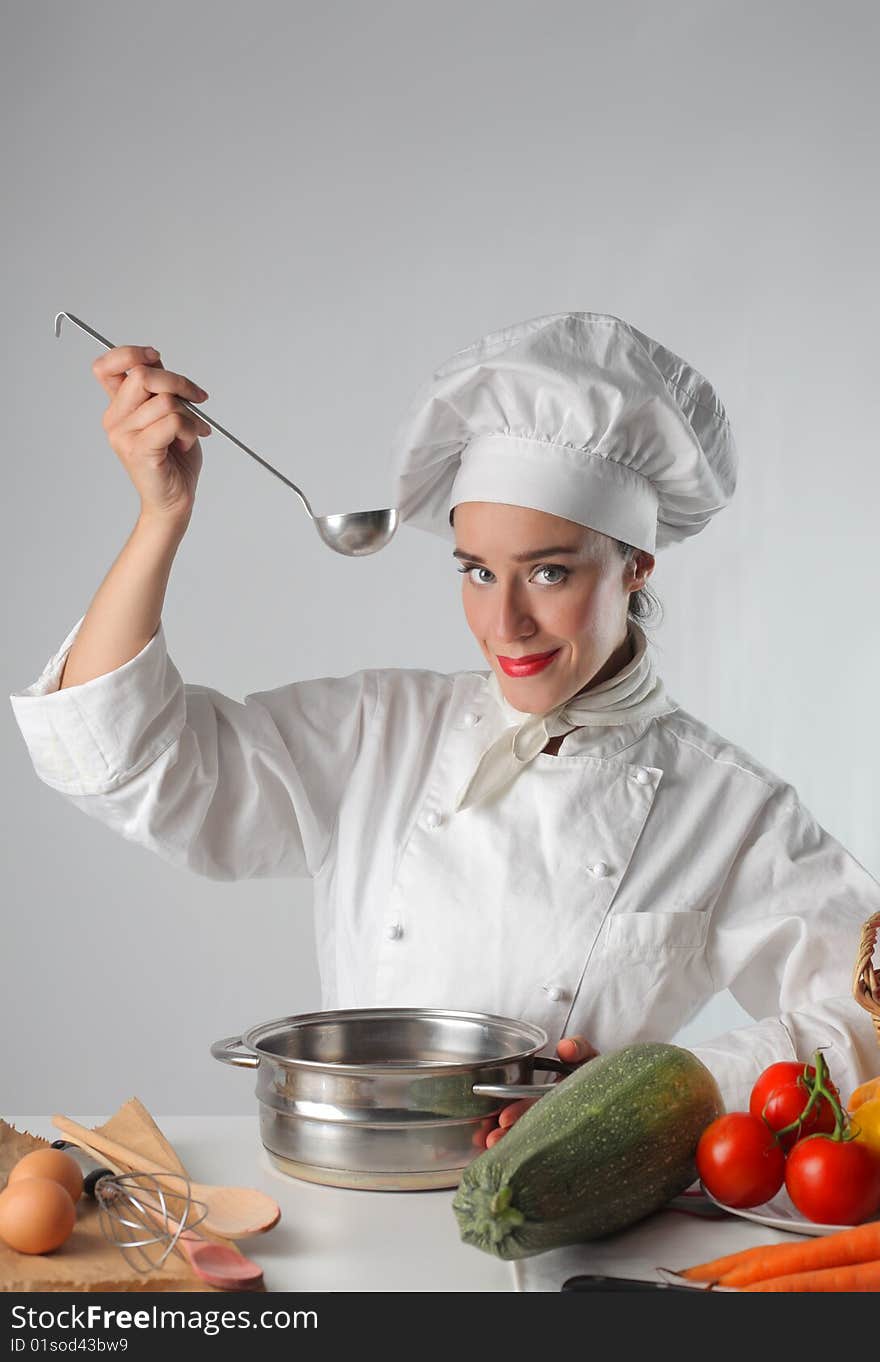 Female cook preparing a recipe. Female cook preparing a recipe