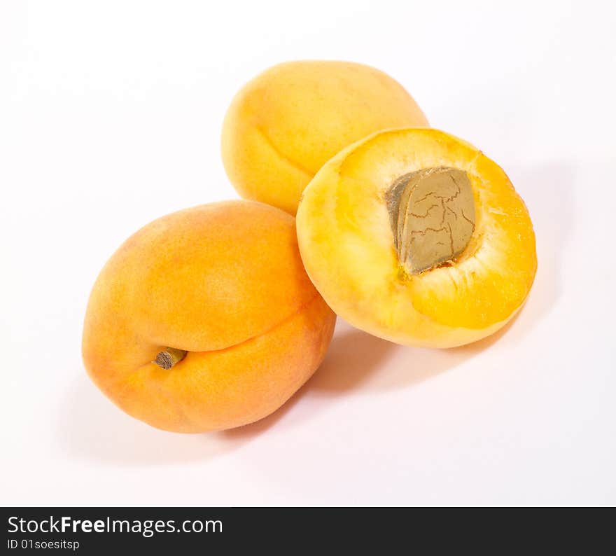 Few apricots on bright background