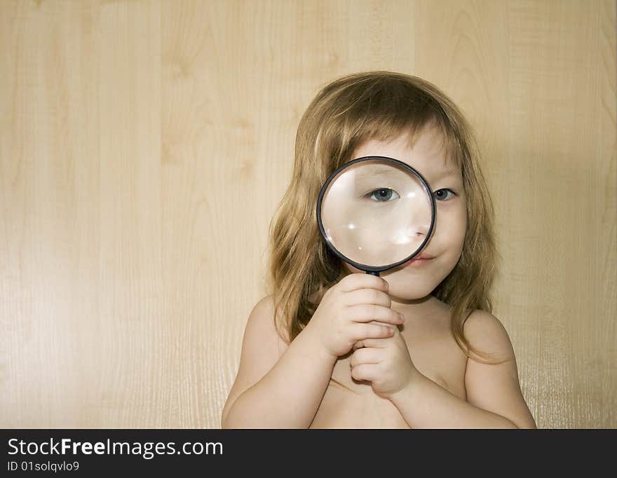 Little girl with big magnifier look for something. Little girl with big magnifier look for something