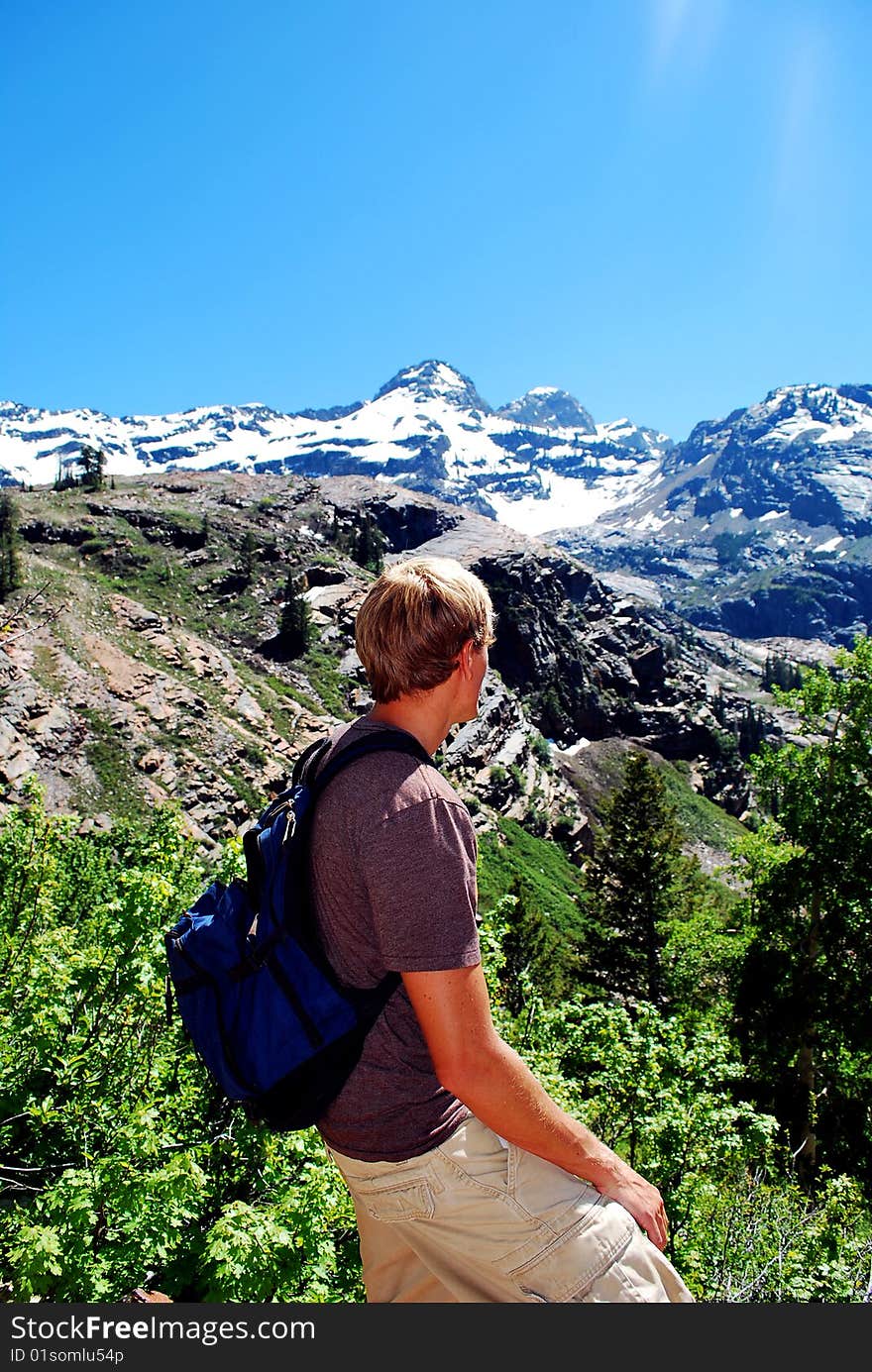 A man looking over a mountain valley during a hike. A man looking over a mountain valley during a hike