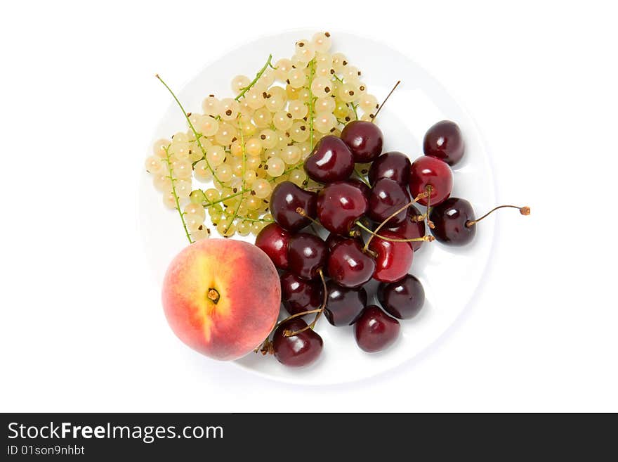 White currant, cherry and peach on white plate. White currant, cherry and peach on white plate