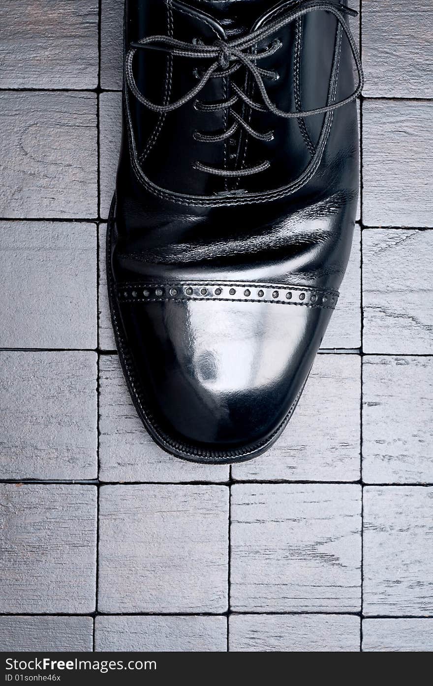 Black leather business shoe on a dark background