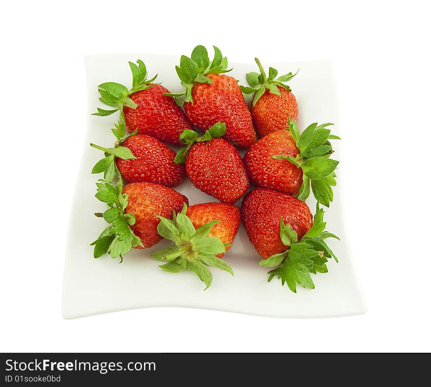 Ripe strawberry on a white square plate