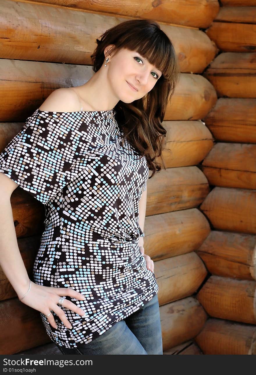 Beautiful young smiling girl at the wooden house. Beautiful young smiling girl at the wooden house