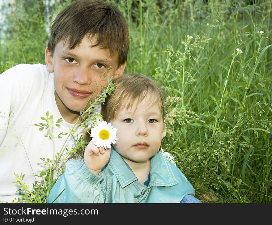 Boy and girl sit on the grass. Boy and girl sit on the grass