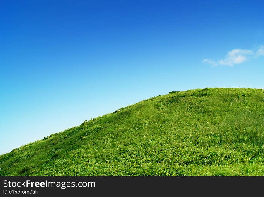 Green grass field under clear blue sky. Green grass field under clear blue sky