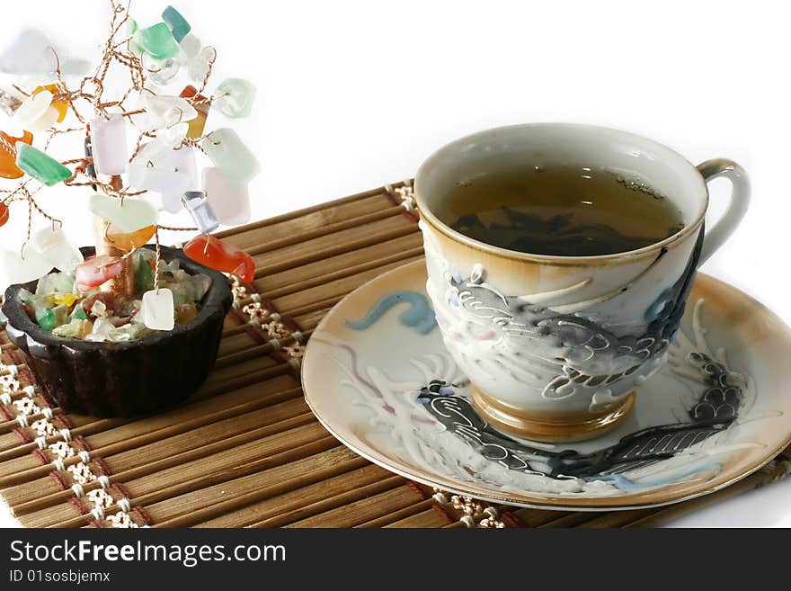 Cup of green tea and cash isolated tree on a white background