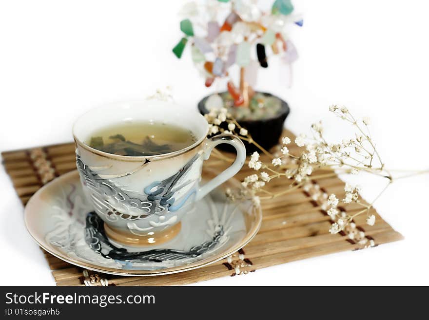 Cup of green tea and cash isolated tree on a white background