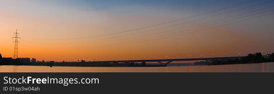 Panorama of the bridge against the sunset sky