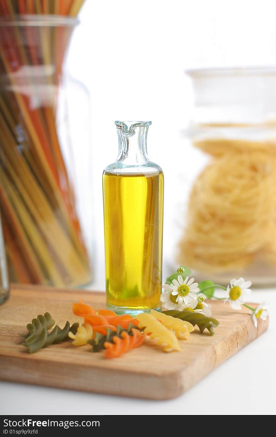 Pasta with oil bottle and chamomile