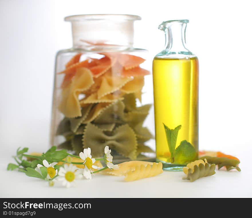 Raw pasta with oil bottle