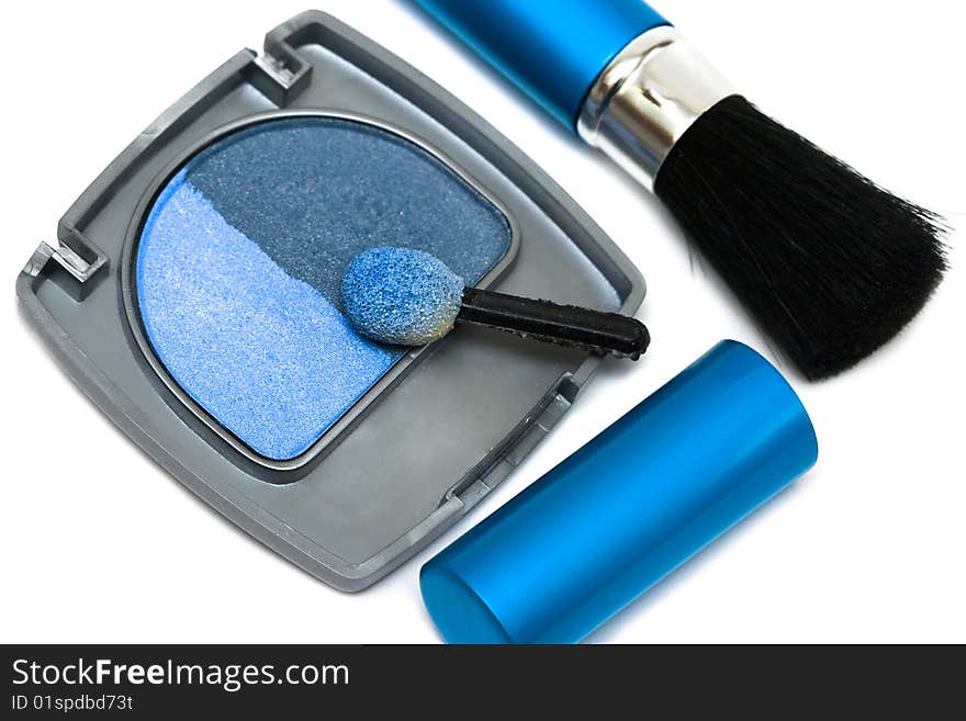 Blue make-up eyeshadows and cosmetic brush