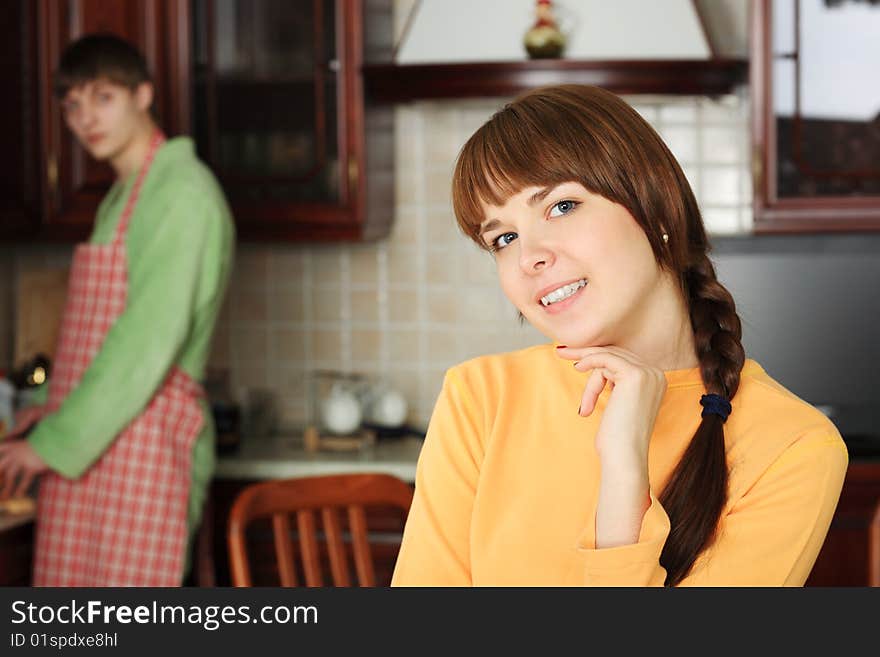 Happy young couple on a kitchen at home.