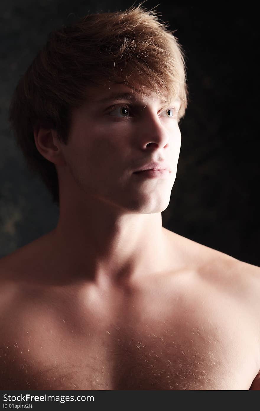 Portrait of a strong muscular male model. Shot in a studio. Portrait of a strong muscular male model. Shot in a studio.