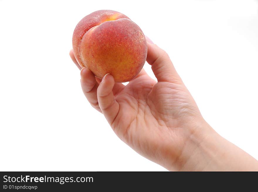 Hand taking a peach. Isolated on white background