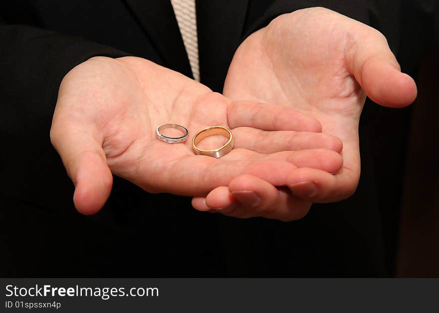 Wedding bands on palm of the Groom. Wedding bands on palm of the Groom