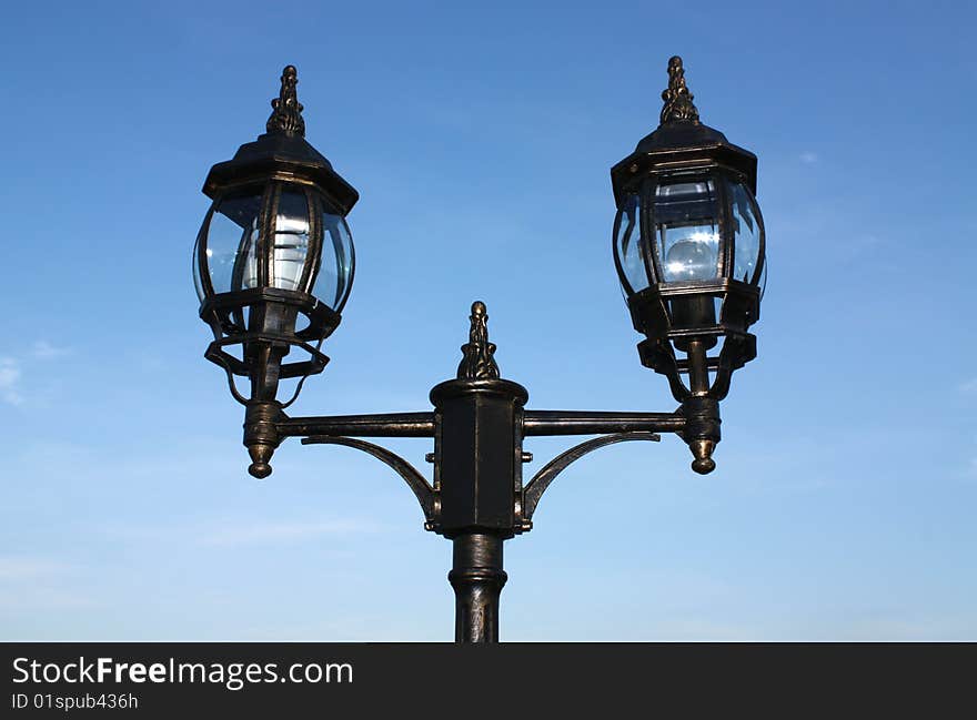 Street lantern on a blue background of the sky