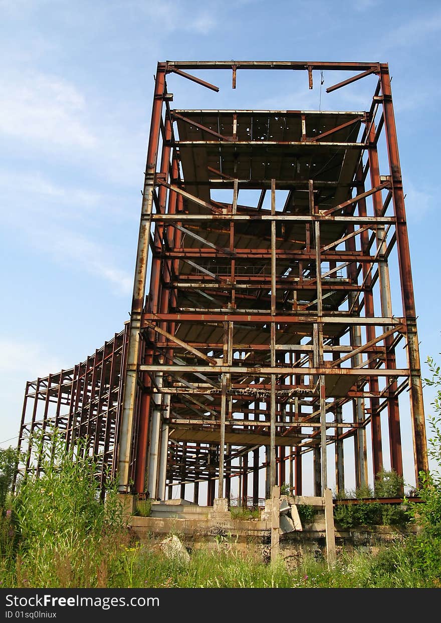 Incomplete construction of the production, metal structures on the background of the sky. Incomplete construction of the production, metal structures on the background of the sky.