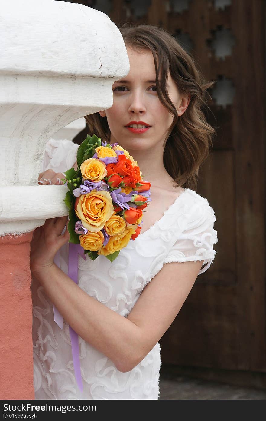 Portrait of the beautiful bride with a wedding bouquet from roses