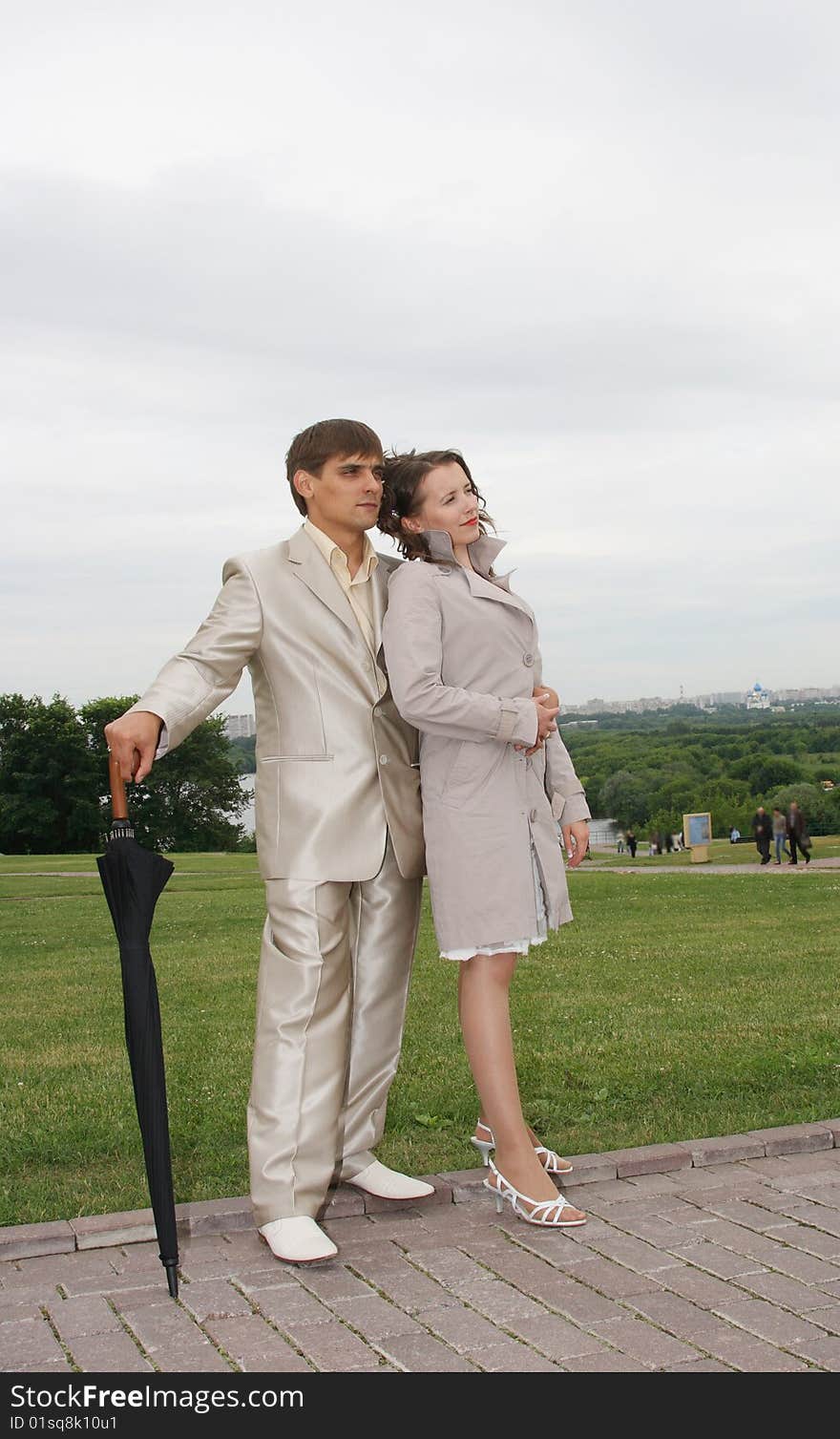 Newly-married couple on wedding walk in the cool afternoon