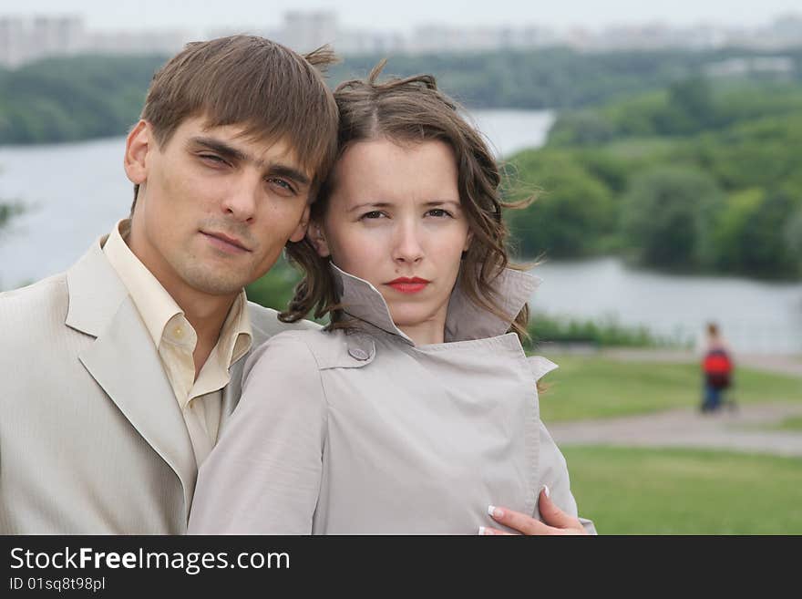 Newly-married couple on wedding walk in the cool afternoon