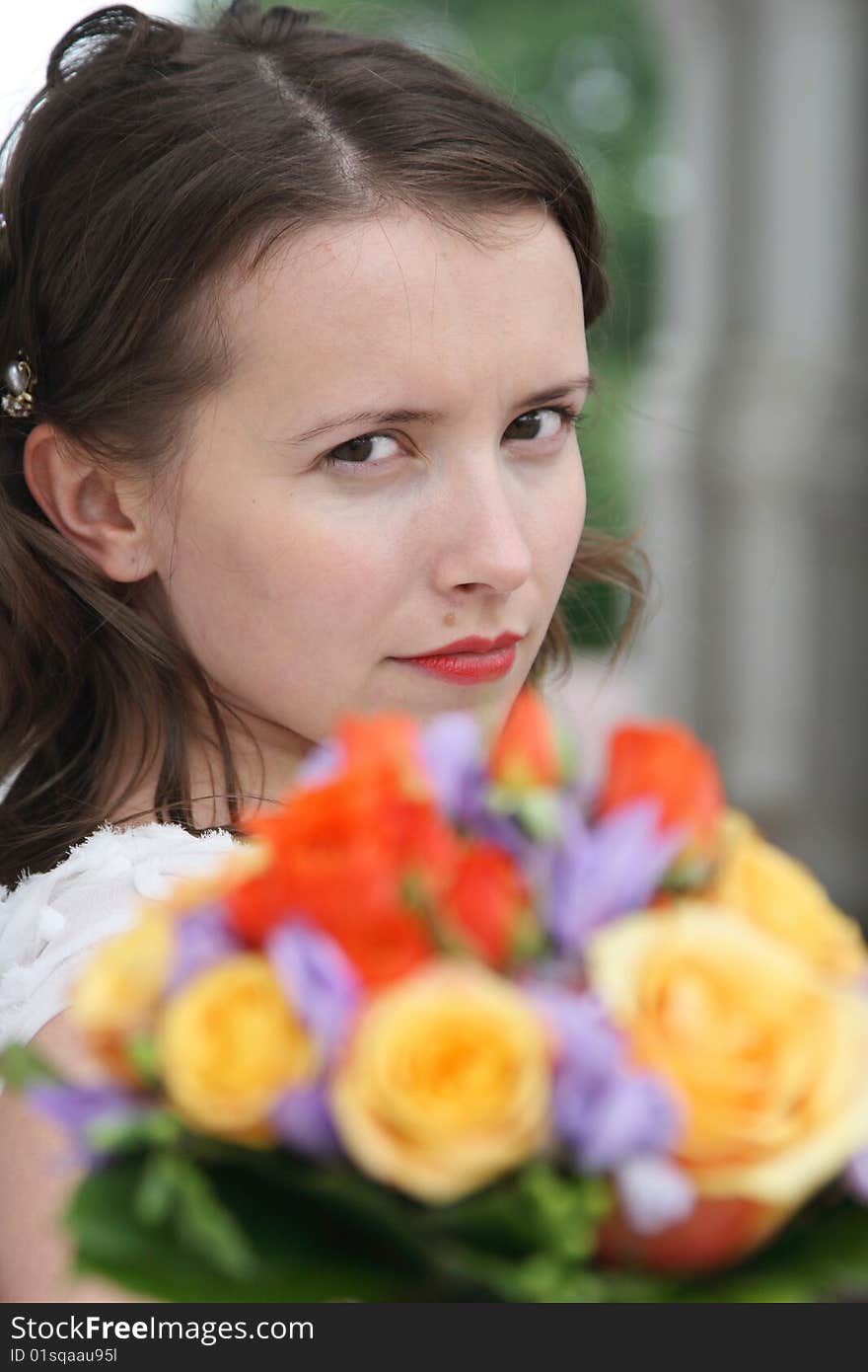 Portrait of the beautiful bride with a wedding bouquet from roses