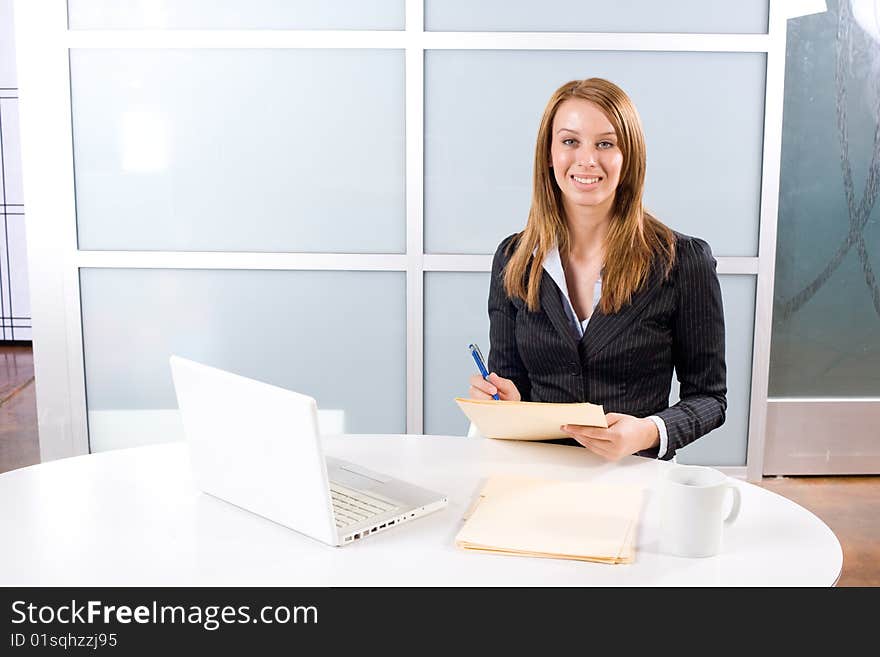 Business Woman Writing Notes At Desk