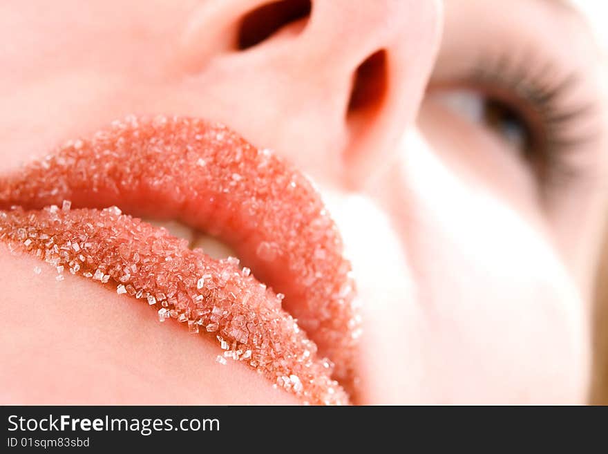 Woman's red lips coated with scattered sugar. Woman's red lips coated with scattered sugar