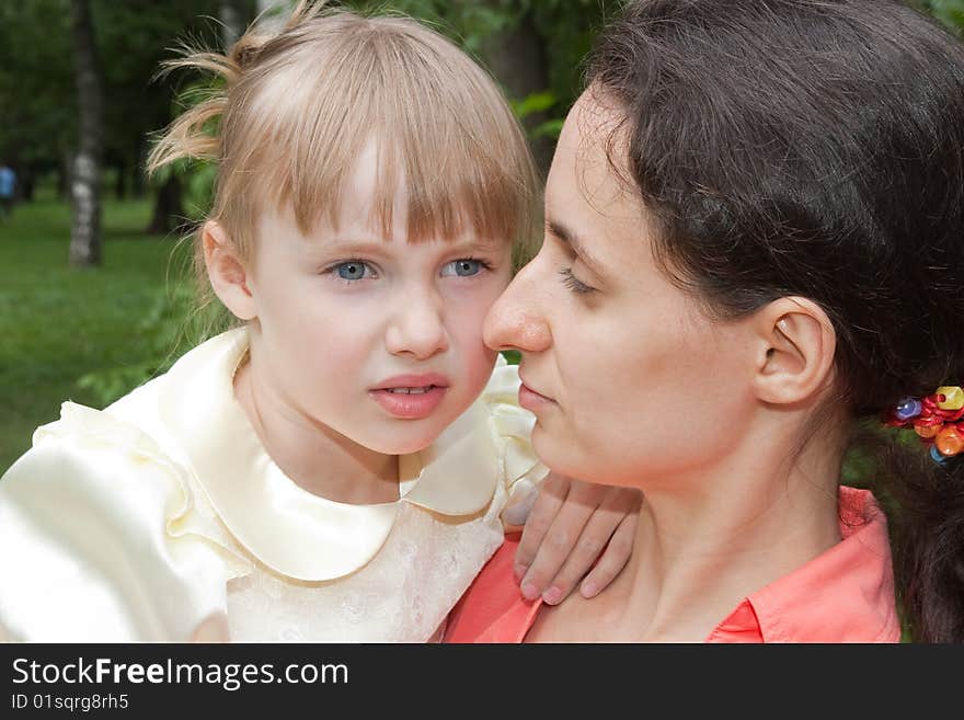 Scared girl holded by her mother