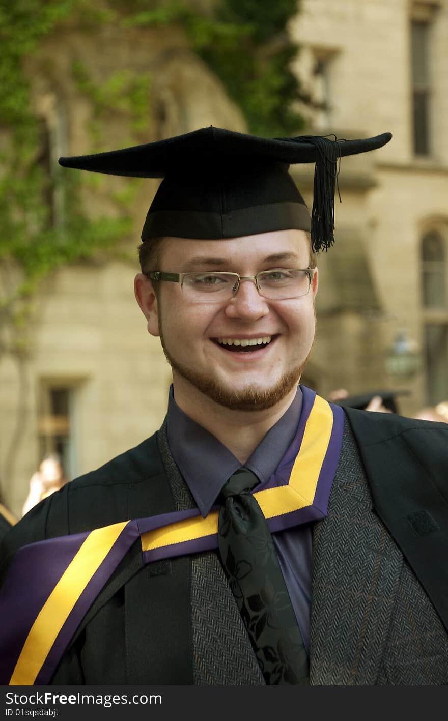 Portrait of happy graduate outdoors