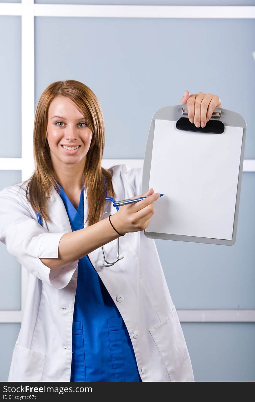 Female doctor holding blank chart in modern hospital