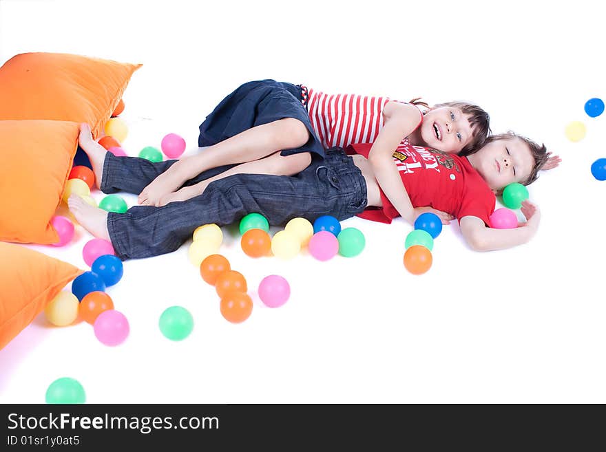 A lovely kids are playing with balls, studio shot