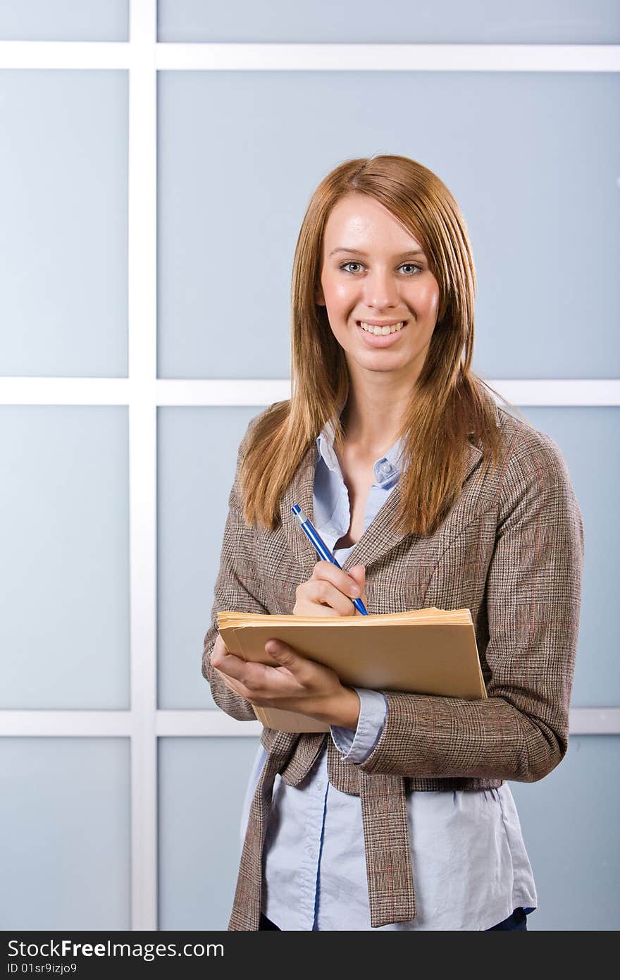 Business Woman Writing notes at desk