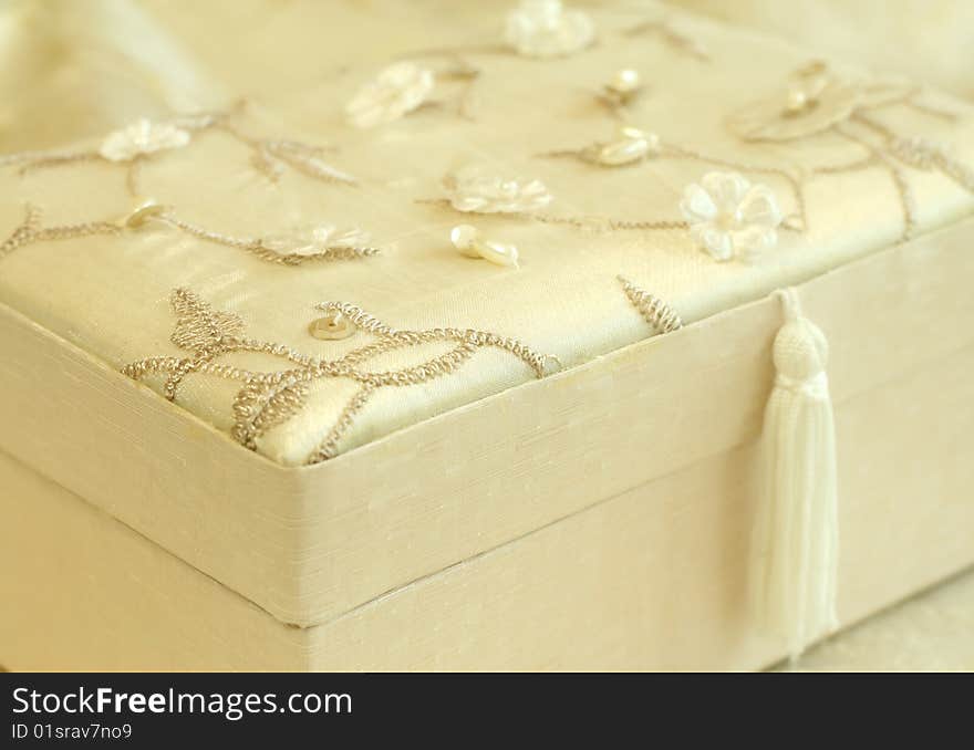 Beautiful gift box sheathed by silk with an embro