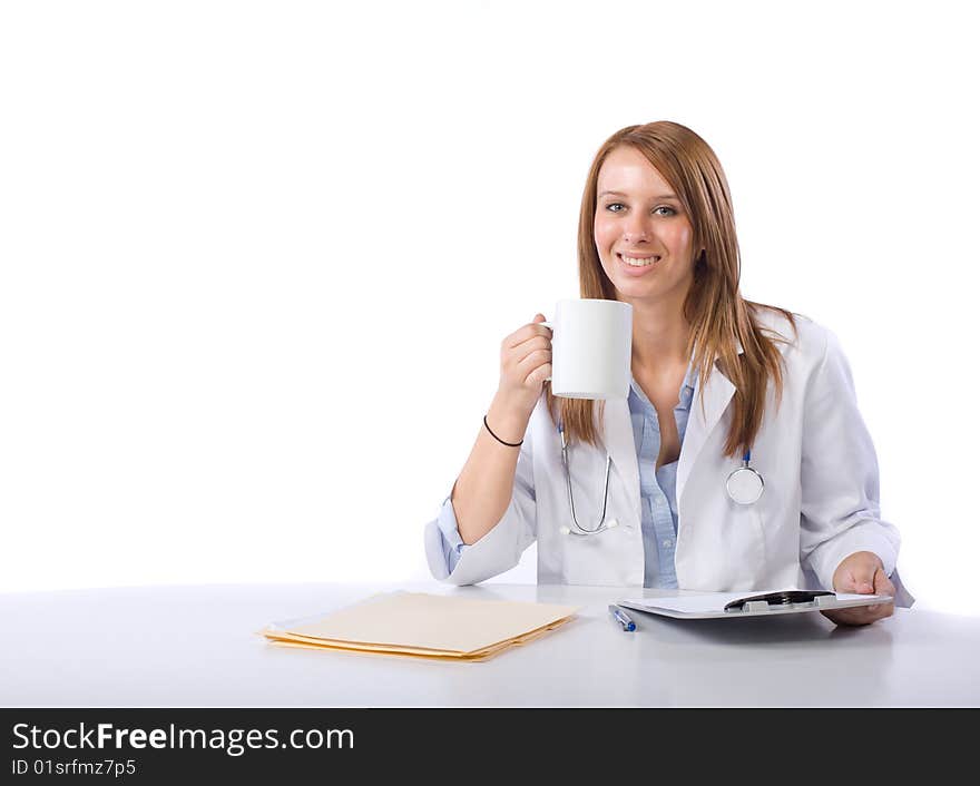 Female doctor in a modern office drinking coffee