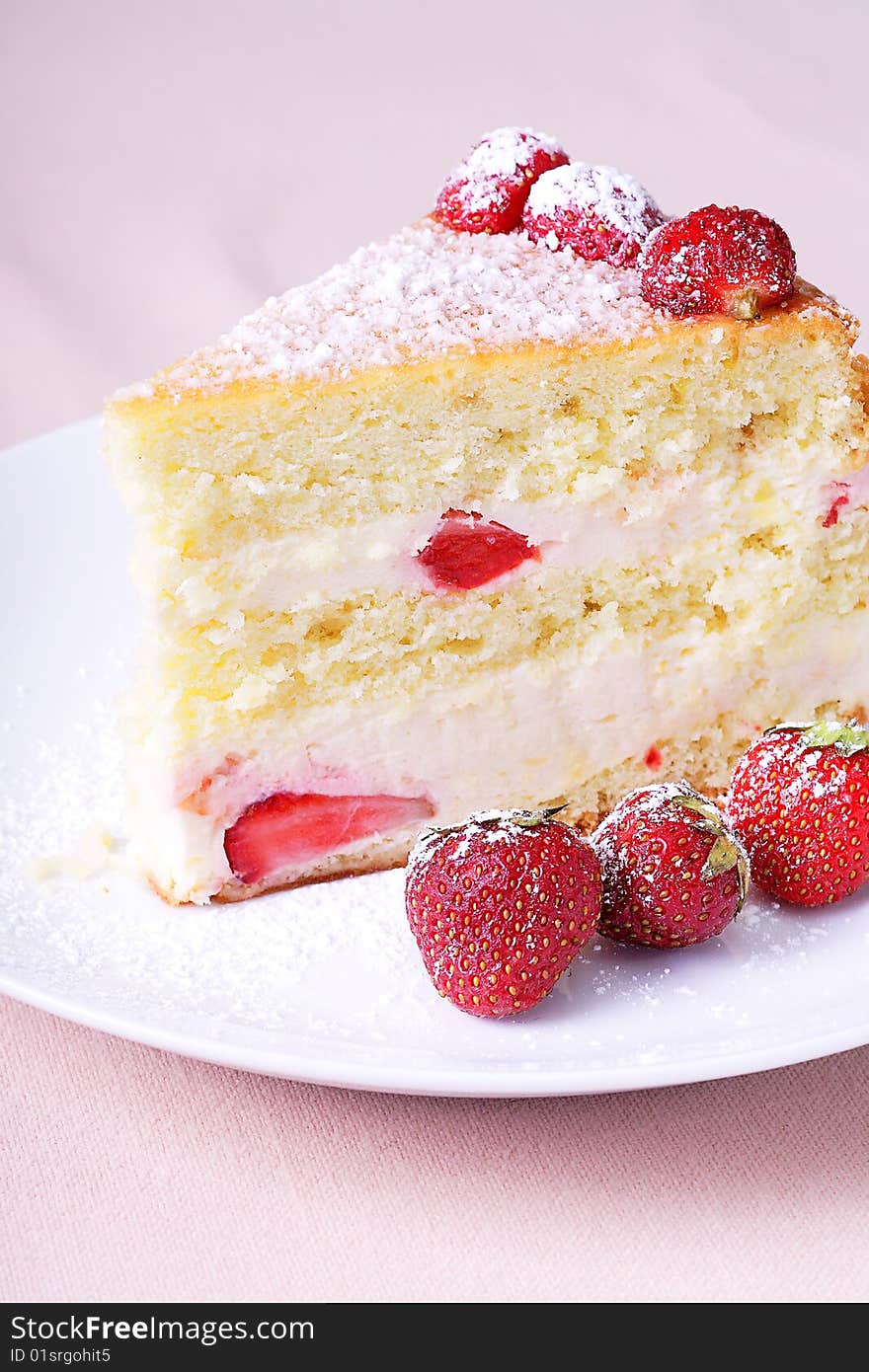 Slice of delicious moist spongecake filled with strawberry whipped cream. Slice of delicious moist spongecake filled with strawberry whipped cream