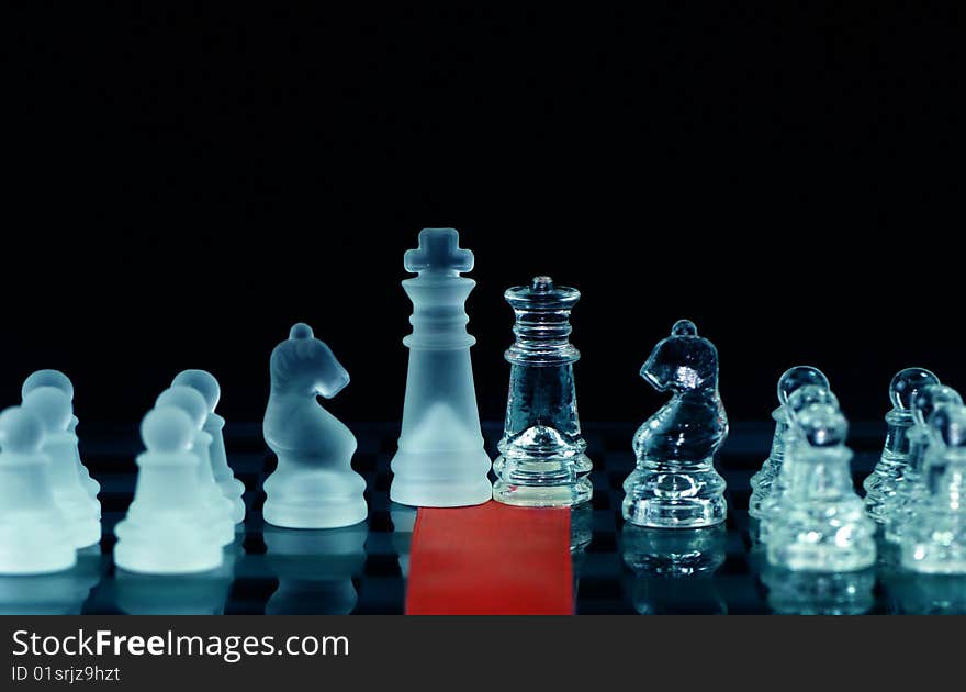 Chess and red ribbon on chess board with black background