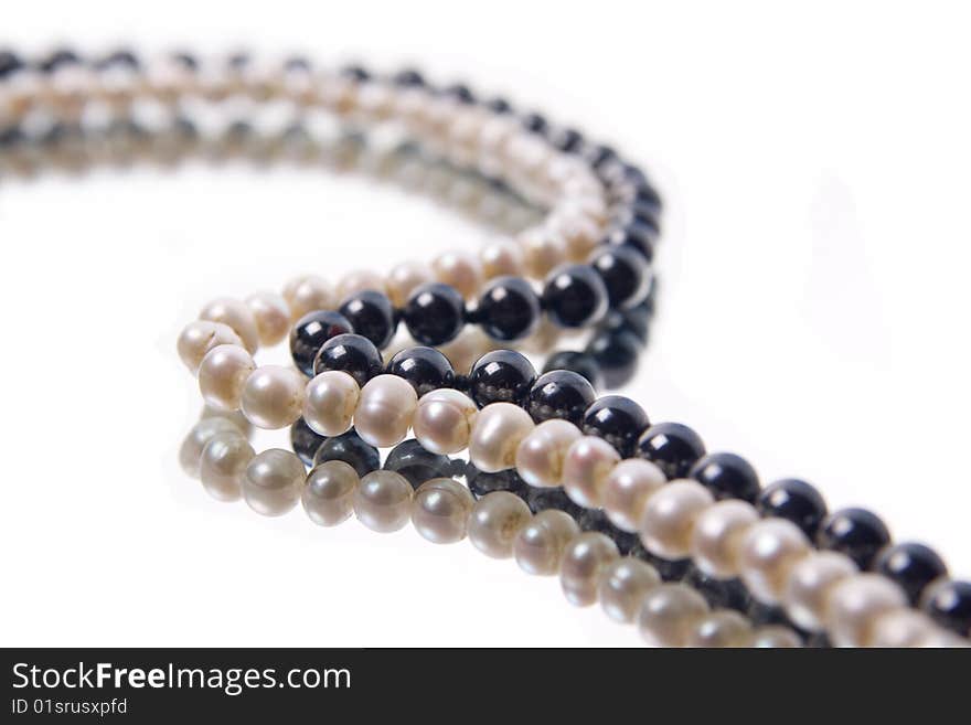 White and black pearl beads on white background