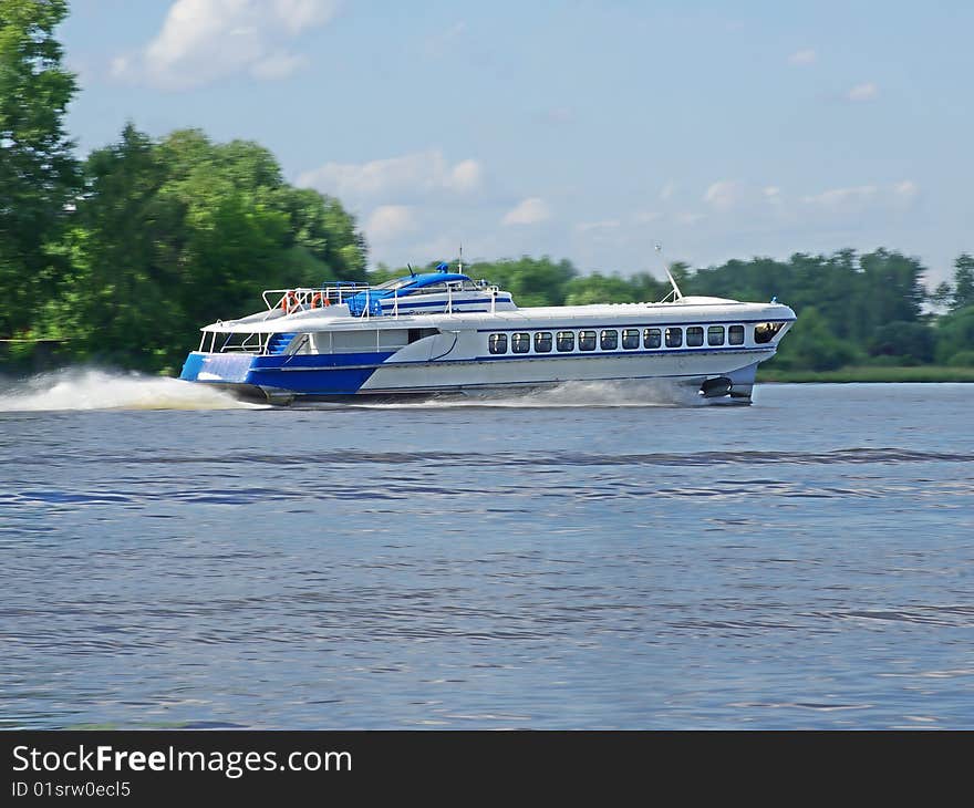 High- speed passenger hydrofoil sheep flies on the river. High- speed passenger hydrofoil sheep flies on the river