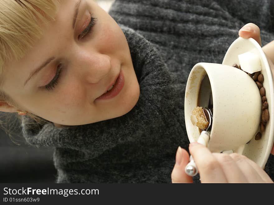 Beautiful young girl with a cup of hot coffee drink. Beautiful young girl with a cup of hot coffee drink